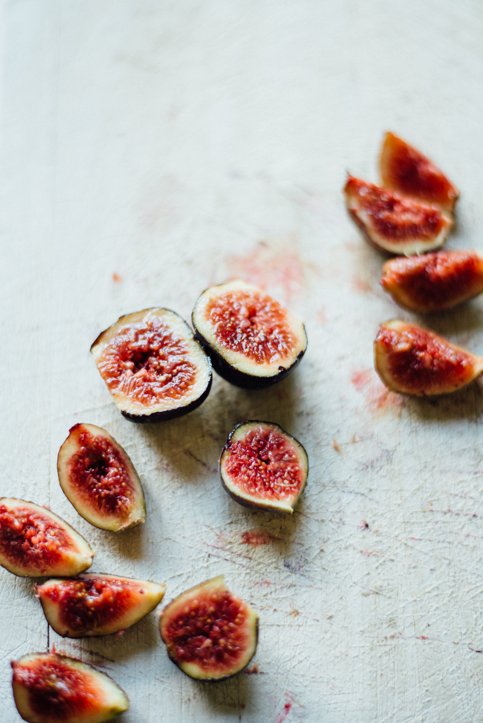 fresh figs split on wooden cutting board