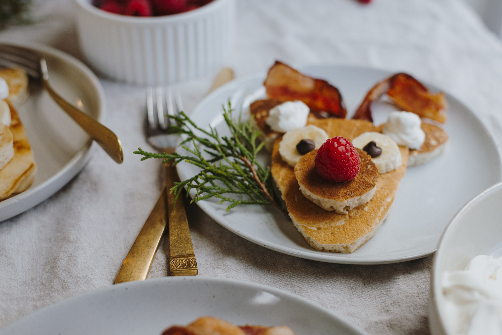 christmas morning reindeer pancakes with raspberry nose and banana eyes